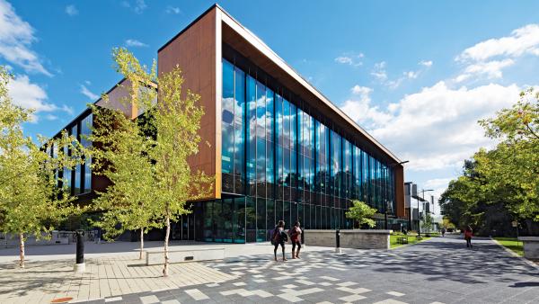Two students walking outside the Hazel McCallion Academic Learning Centre.