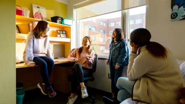 Students hanging out in residence room at Oscar Peterson Hall.