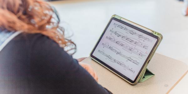 Student looking at sheet music on a tablet