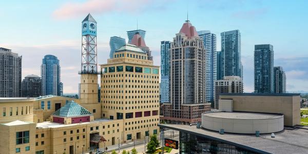 View of Mississauga city hall and clock tower, with condo buildings behind it