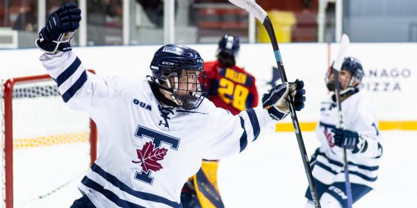 A U of T women's hockey player celebrating scoring a goal