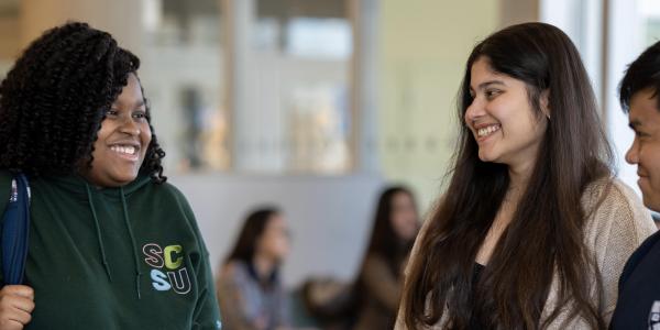 Four students talking to each other.