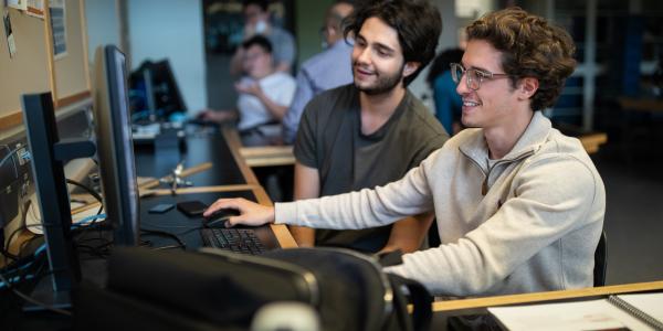 Two students using a computer.
