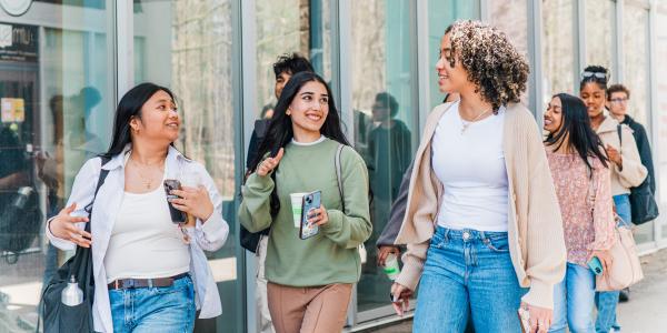 Students walking past building.