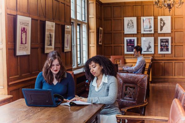 Students sitting at desk in reading room.