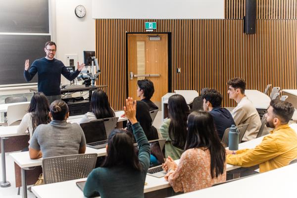 Professor standing in front of class.
