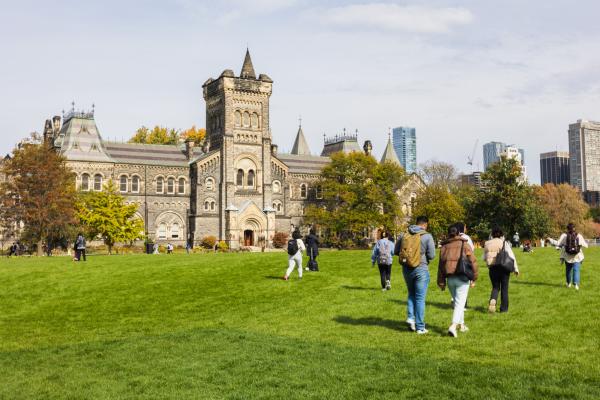 Students walking across Front Campus toward University College on a fall day