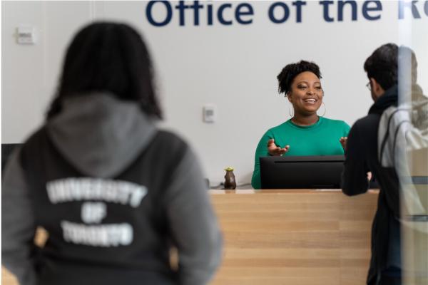 a woman helping out a student