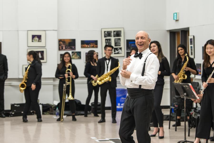 Students playing brass instruments in a gymnasium.