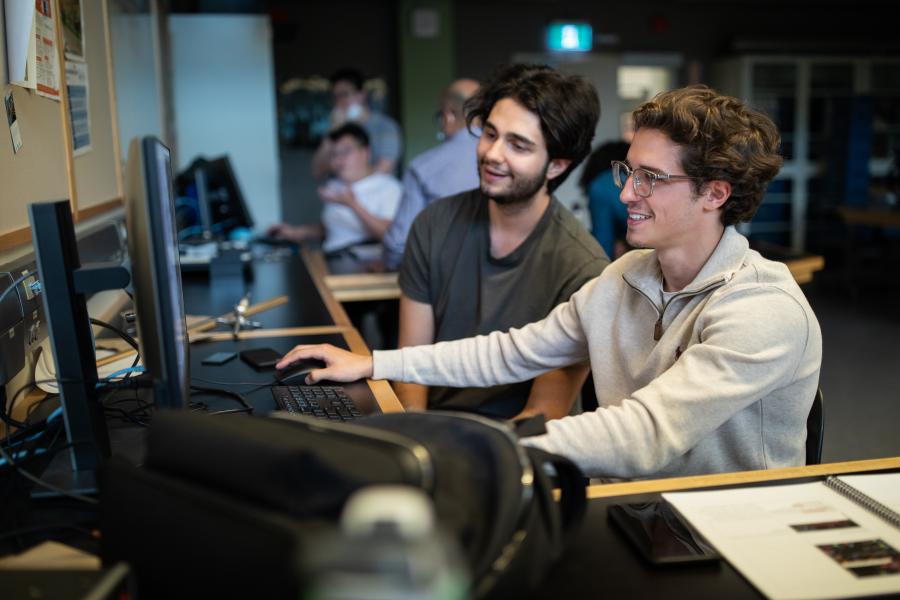 Two students using a computer.