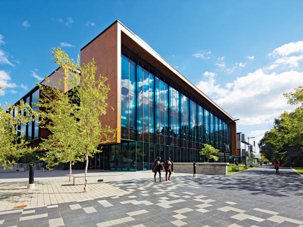 Two students walking outside the Hazel McCallion Academic Learning Centre.
