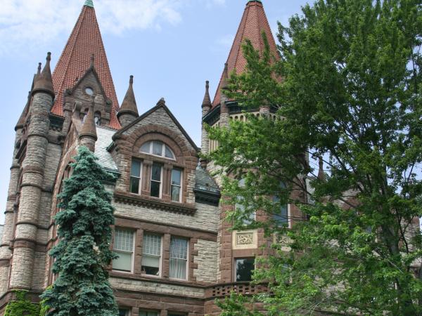 Exterior of Victoria College, and old building with peaked roofs and a large brick facade