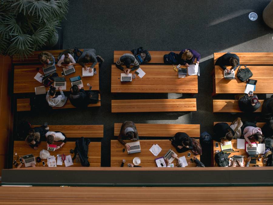 Students using laptops on tables.