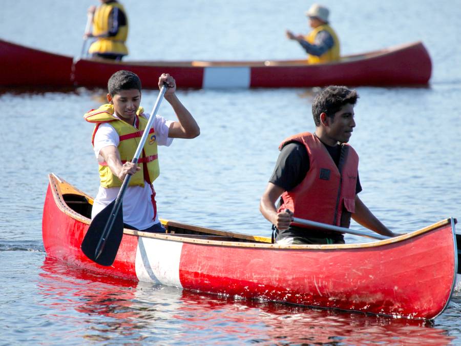 Two students rowing a canoe.