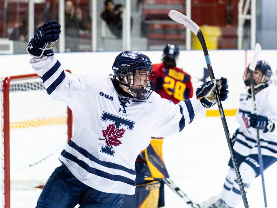 A U of T women's hockey player celebrating scoring a goal