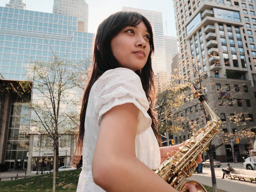 Bea holding saxophone in park