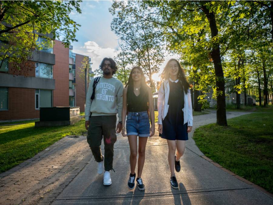 three students walking around campus