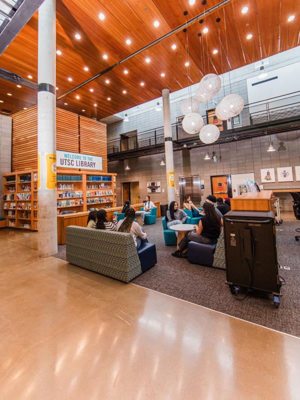 Students relax and study in the bright lobby of the UTSC Library.