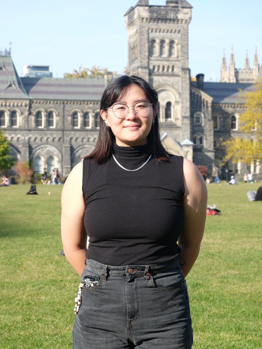 Photo of U of T student in front of University College building