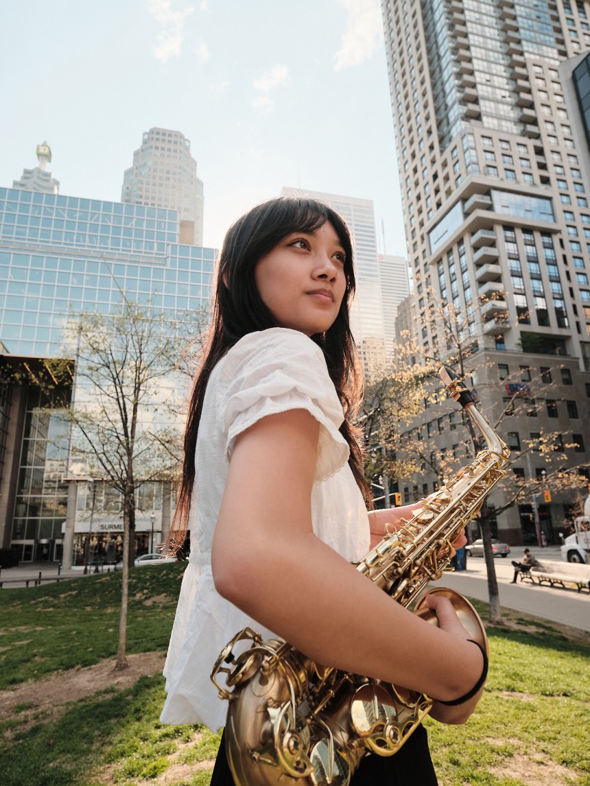 Bea holding saxophone in park