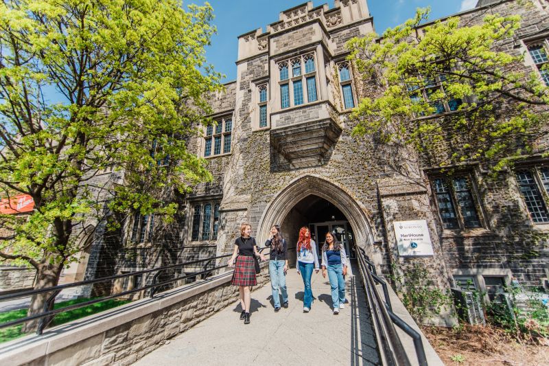 Four students walking outside of Hart House