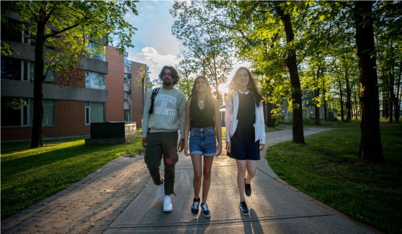 three students walking around campus